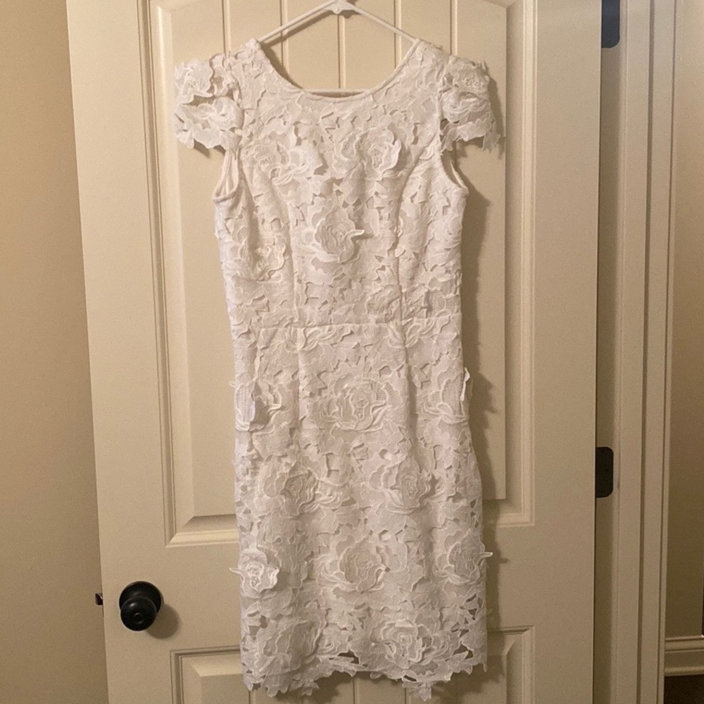 White lacy dress. Never worn. Would be perfect for Wedding events for bride